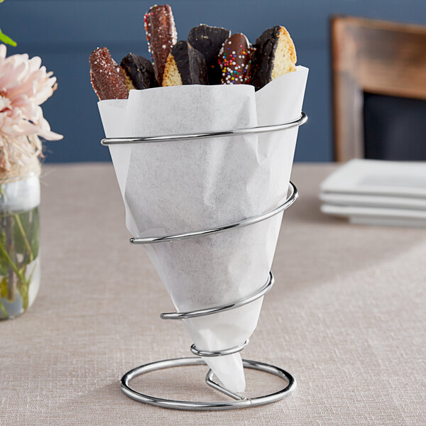 A Clipper Mill chrome spiral cone basket with chocolate covered cookies inside.