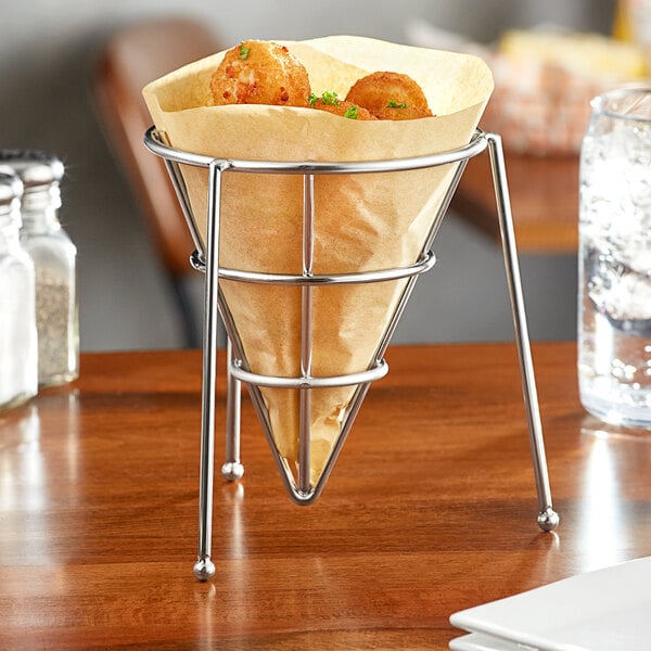 A Clipper Mill stainless steel cone basket with food inside.