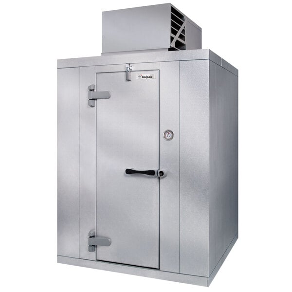 A large silver metal Kolpak walk-in freezer with a door open.