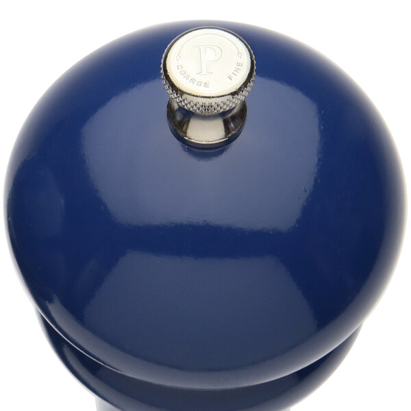 A Chef Specialties cobalt blue pepper mill with a silver top and knob.