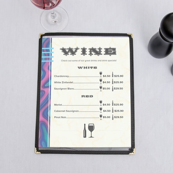 An 8 1/2" x 11" menu with a wave border on a table with wine glasses and a glass of wine.