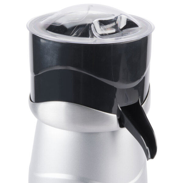 A silver and black juicer lid with a white background.