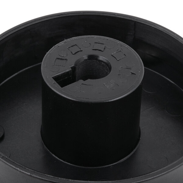A black plastic cylinder with a hole in the center, the AvaMix filter basket assembly.
