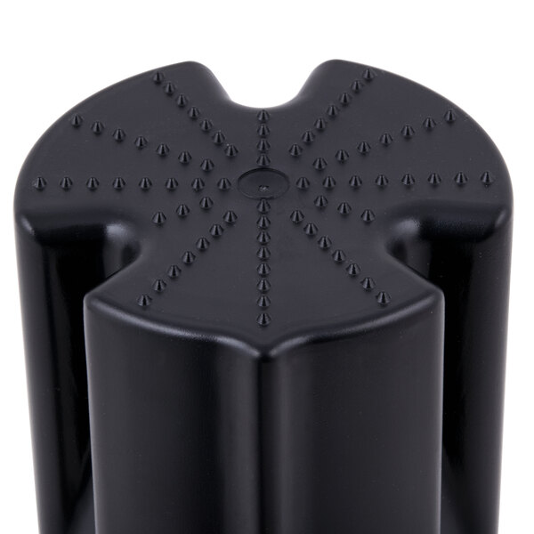 A black plastic pusher with spikes on it.