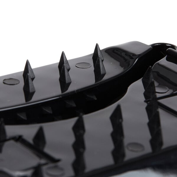A black plastic hand guard with spikes.