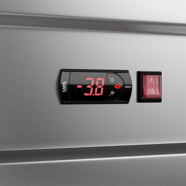 A stainless steel reach-in freezer with a digital temperature display and control panel.