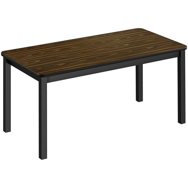 A Correll walnut library table with black legs.