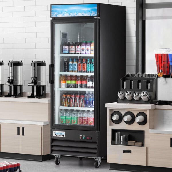 An Avantco black swing glass door merchandiser refrigerator full of drinks with LED lighting.