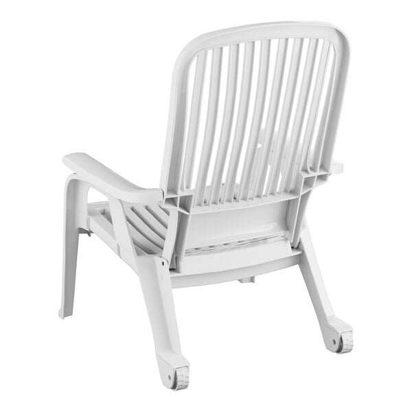 A white plastic Grosfillex Bahia chair with armrests.