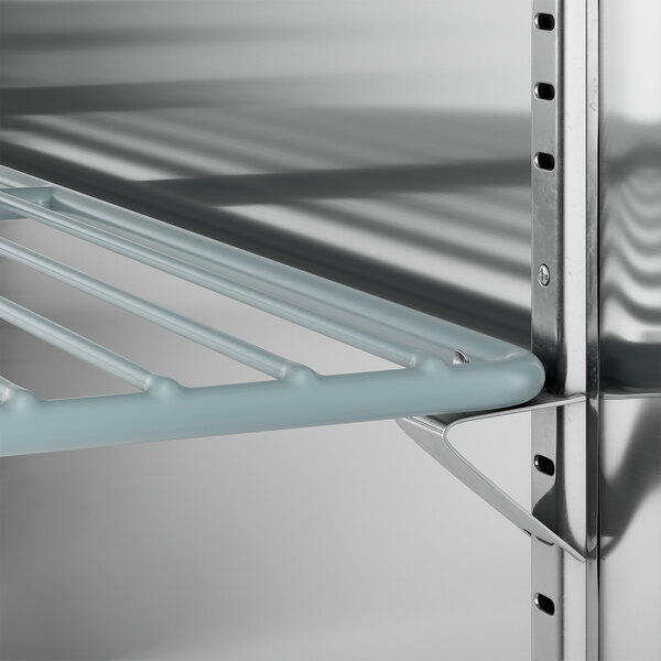 A metal shelf inside an Avantco black back bar refrigerator.