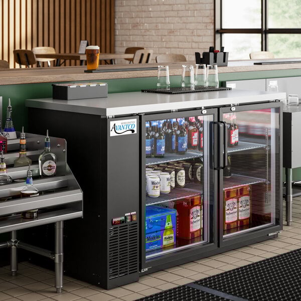 An Avantco back bar refrigerator with bottles of alcohol on shelves.
