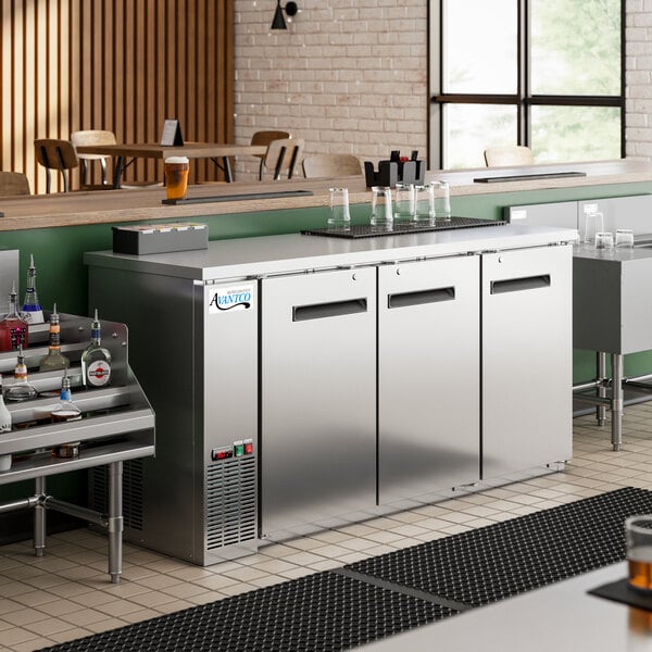 An Avantco stainless steel back bar refrigerator with bottles inside.
