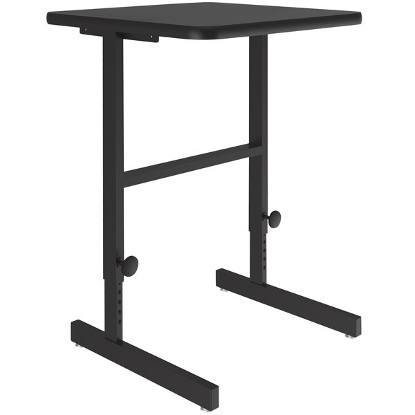 A Correll black granite high pressure laminate top adjustable standing height work station on a metal base.