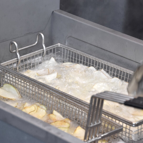 A basket of food in a Globe stainless steel gas floor fryer.