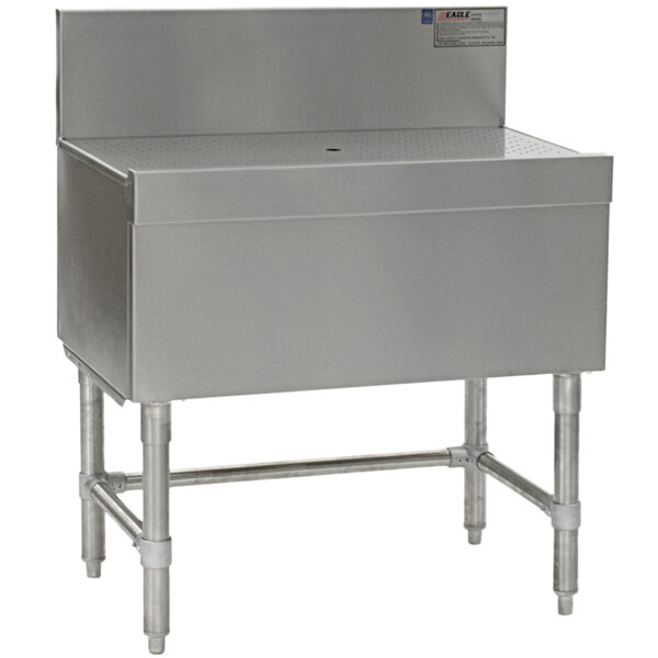An Eagle Group stainless steel workboard with a drain on a white surface.