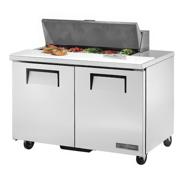 A True refrigerated sandwich prep table with food on a counter.