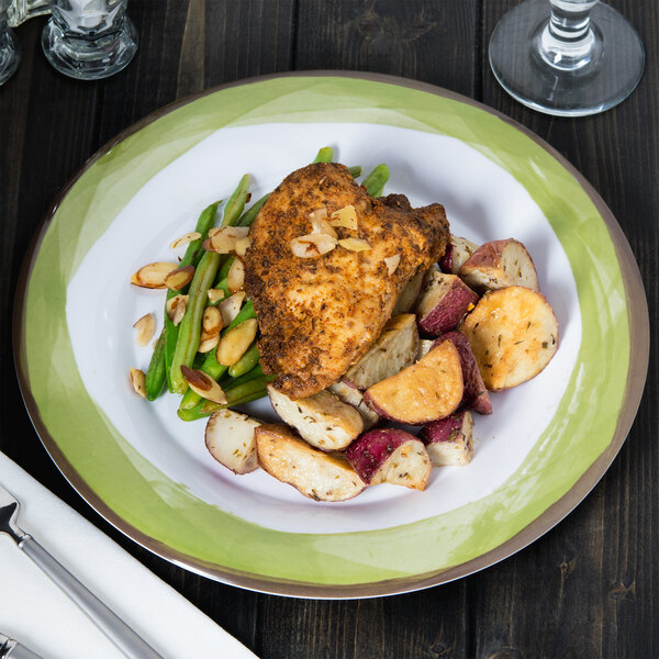 A Kanello melamine plate with chicken, potatoes and green beans on a table.