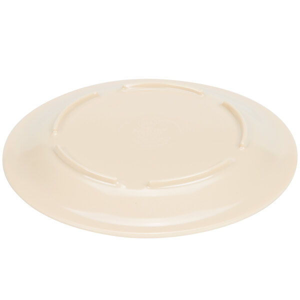 A beige melamine plate with a narrow rim.
