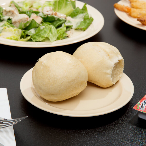 A Thunder Group Nustone Melamine plate with food on it next to a salad.