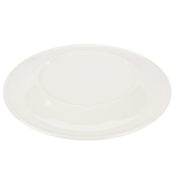 A white round melamine plate with a wide ivory rim with a yellow circle on the edge.