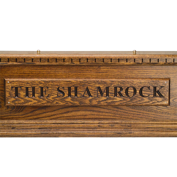 A dark oak Micro Matic Kool-Rite Irish Coffin Box with a shamrock carved in it.
