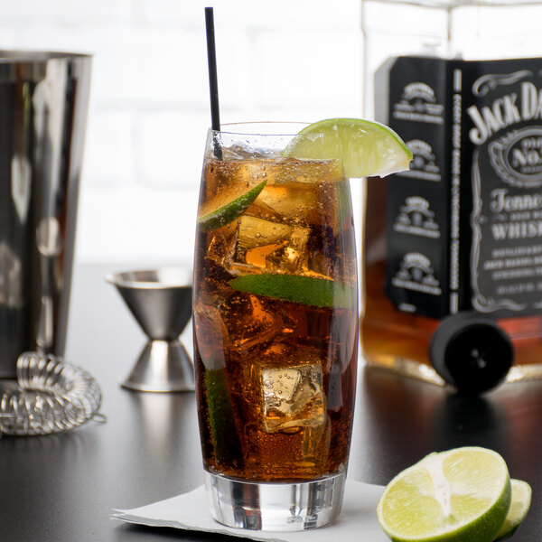 A Reserve by Libbey highball glass filled with a drink and ice cubes with a lime wedge.