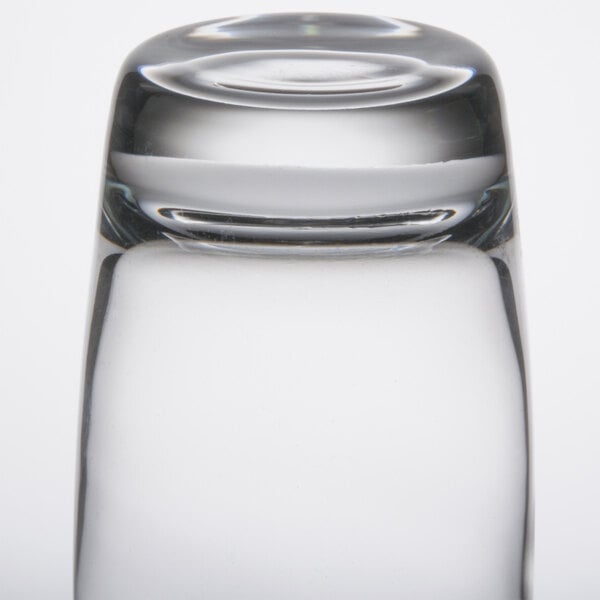 A close up of a Libbey highball glass with a small hole in the middle.