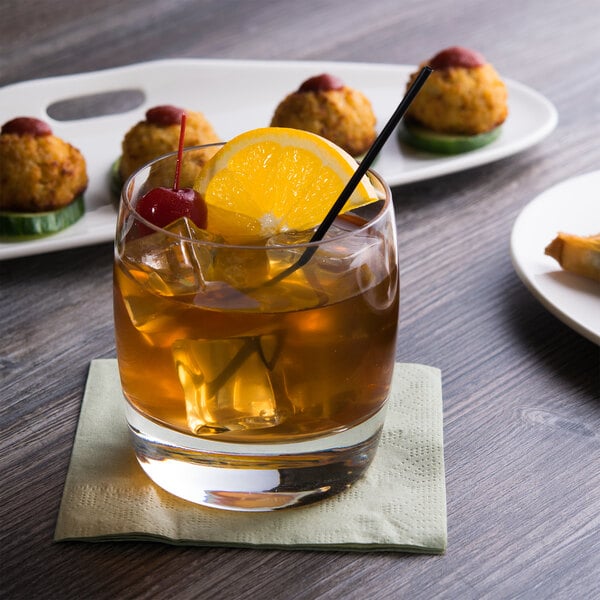 A Reserve by Libbey Symmetry old fashioned glass with ice, a slice of orange, and a cherry on top.