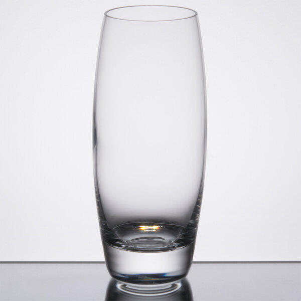 A close-up of a clear Reserve by Libbey highball glass on a reflective surface.