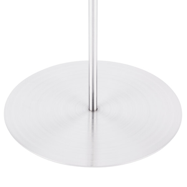 A Clipper Mill stainless steel tower with a metal pole.