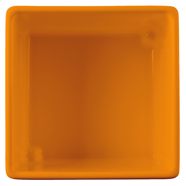 A Tablecraft orange square bowl with straight sides.