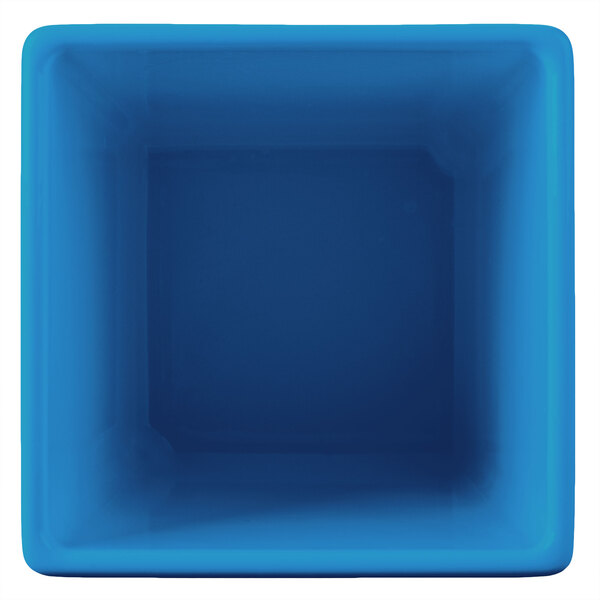 A blue square Tablecraft bowl with a white border.