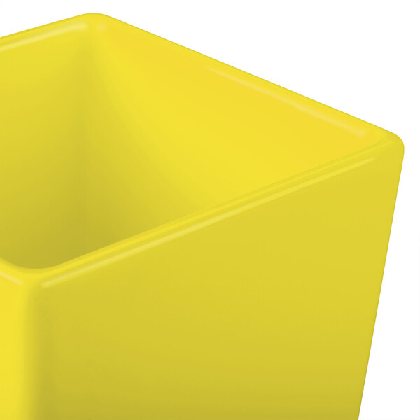 A yellow Tablecraft Contemporary Collection straight sided bowl with a lid.