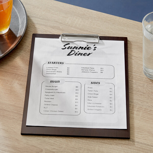 A dark wood Choice menu holder with a menu on a table.