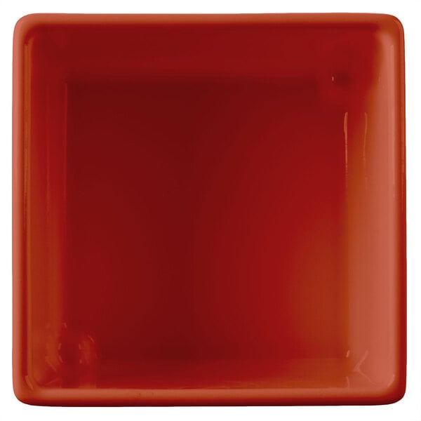 A red square Tablecraft contemporary copper bowl with a white border.