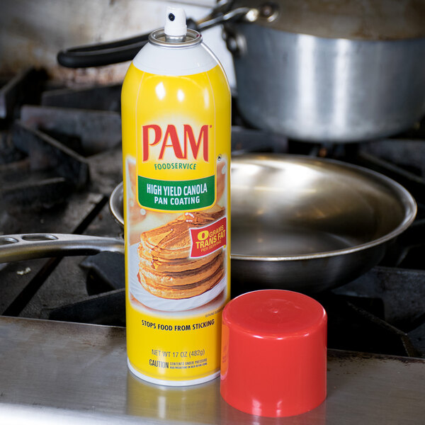 A silver PAM can of pancake cooking spray over a silver pan.