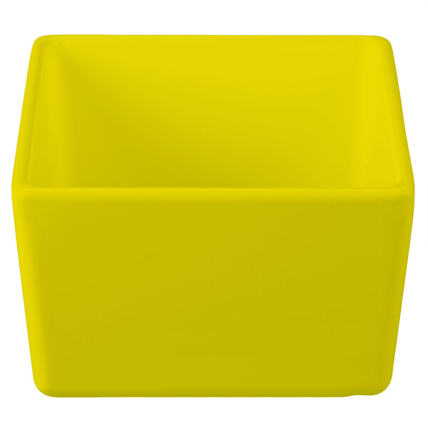 A yellow square Tablecraft straight sided bowl.