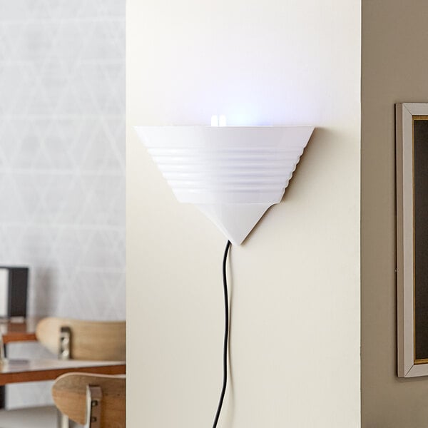 A Lavex Zap N Trap white wall sconce with a blue light on a wall.