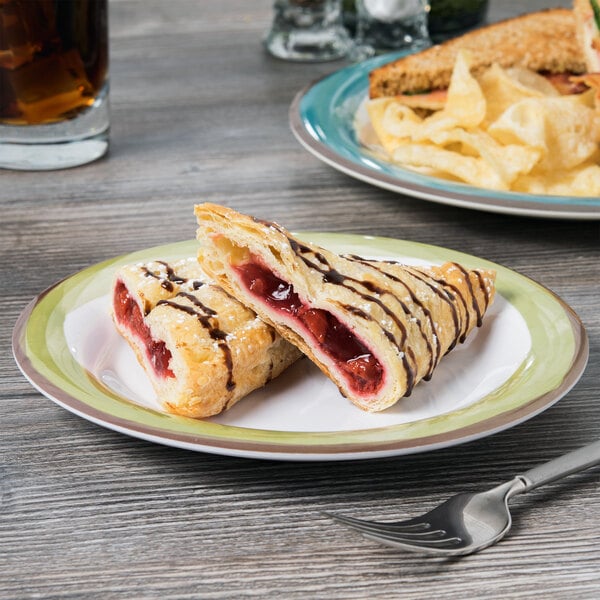 A Kanello melamine plate with a pastry and a drink on a table.