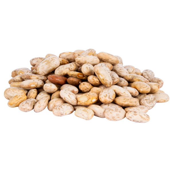 A pile of organic dried pinto beans on a white background.