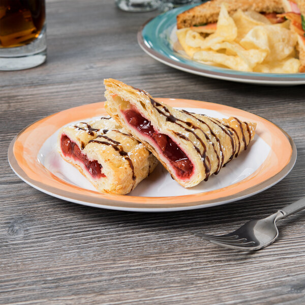 A Kanello white melamine plate with pastries and a fork.