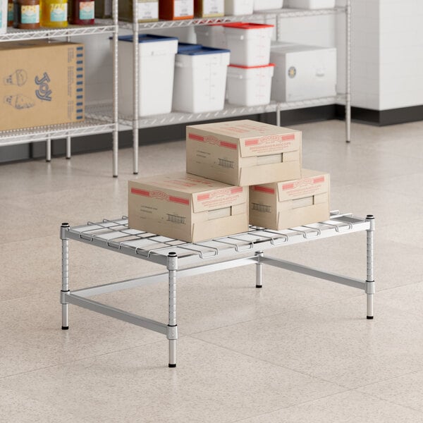 Boxes on a Regency chrome dunnage rack in a room.