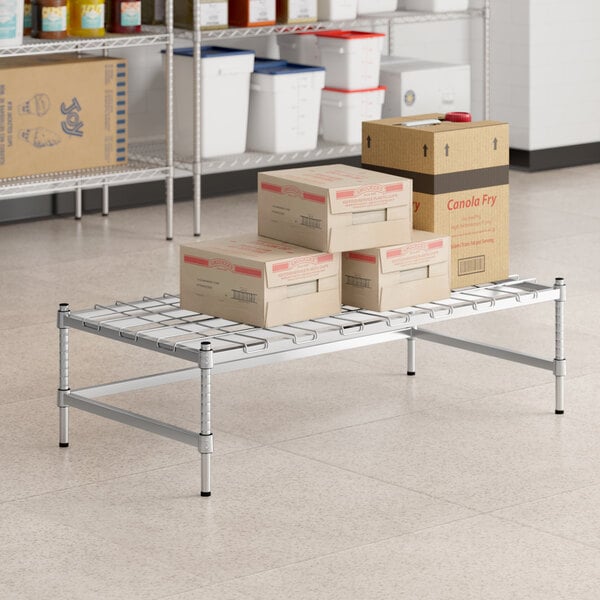 A Regency chrome metal shelf with boxes on it.