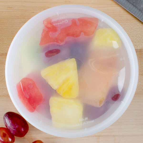 A Pactiv translucent plastic deli container filled with fruit.
