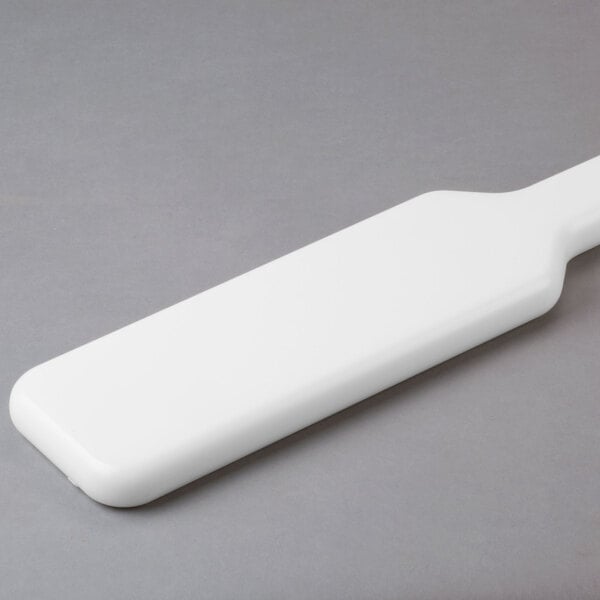 A white plastic rectangular paddle.