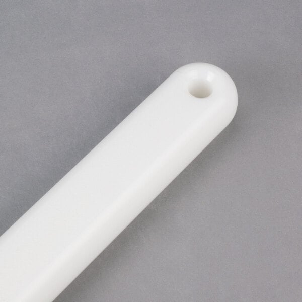 A white plastic Manitowoc ice paddle handle with a hole.
