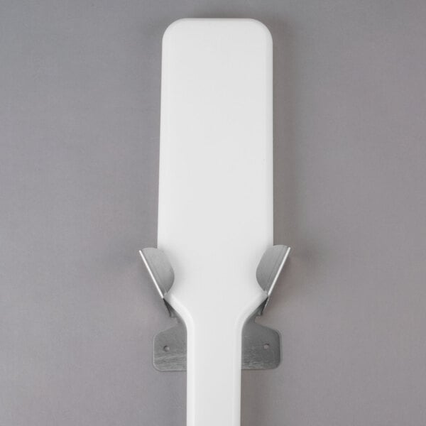 A white rectangular Manitowoc ice paddle with metal corners.