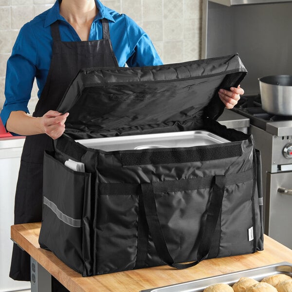 A black heavy-duty insulated soft-sided food delivery bag designed to hold six 2 1/2-inch deep full size food pans.