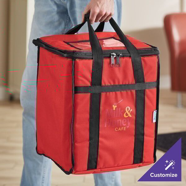 A man holding a red Choice insulated food delivery bag with black straps.