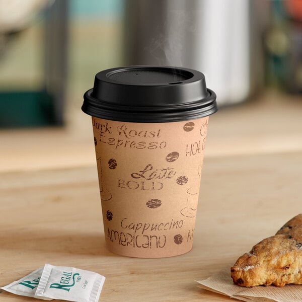 A Choice brown paper hot cup with a black lid on a table with a pastry.